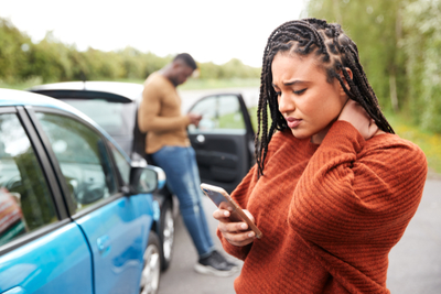 woman after car accident on phone