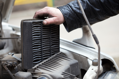 mechanic replacing car filters